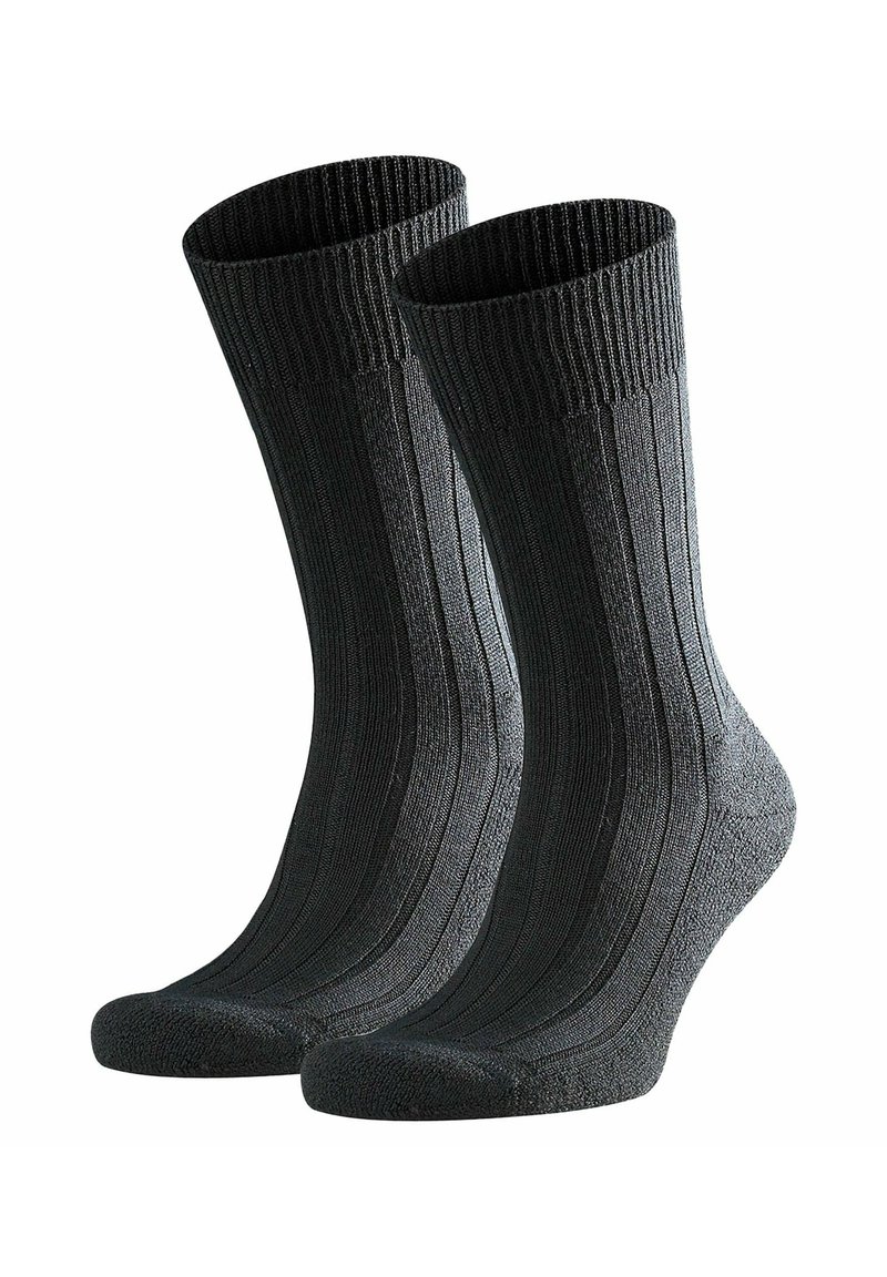 Sorte ribbede bomuldsstrømper med forstærket hæl og tå, der viser en tekstureret overflade og et design i mellemlang længde til læggen.