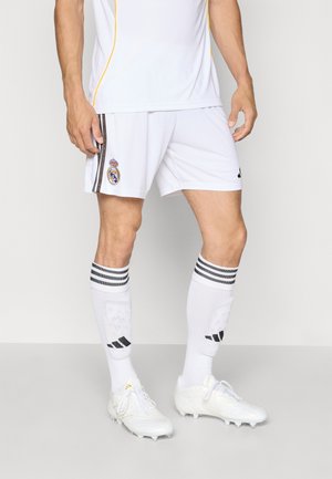 Hvitt fotballtrøye med gule detaljer, kombinert med hvite shorts med lagemblemet. Hvite sokker har svarte striper og logo. Skoene er hvite.