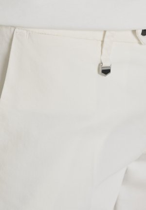 Bijele hlače s prednjim džepom i metalnim detaljem na petlji za remen, izrađene od teksturiranog tkanja.