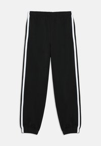 Schwarze Sweatpants mit weißen Seitenstreifen, aus weichem Stoff gefertigt, mit elastischem Bund und schmal zulaufenden Abschlüssen an den Knöcheln.