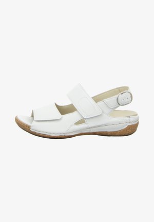 White leather sandal with adjustable Velcro straps, open toe, and cork-like sole. Shaped for comfort with cut-out details on the sides.