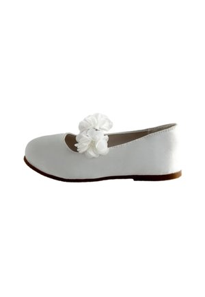 Witte platte schoen met afgeronde neus, bruine zool en decoratieve witte stoffen bloemen over het bovenste bandje, zijaanzicht.