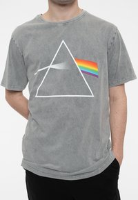 Gray cotton t-shirt featuring a white triangular graphic and a rainbow-striped prism detail. Short sleeves with a relaxed fit and crew neck.