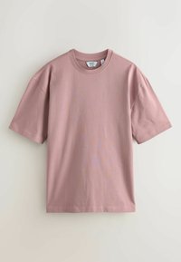 Pink cotton T-shirt with short sleeves, a crew neckline, and a relaxed fit. Smooth texture and no visible patterns or embellishments.