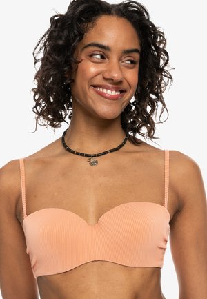 Ferskenfarvet ribbet bandeau bikini-top med sweetheart halsudskæring, justerbare stropper og glat tekstur. Velegnet til badetøj.