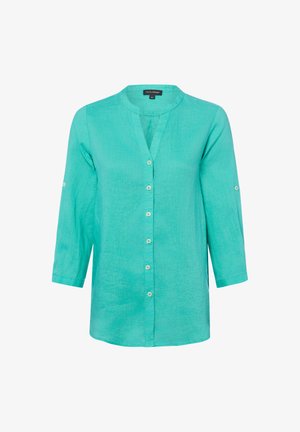 Blusa turchese abbottonata con maniche tre quarti e scollo tondo, caratterizzata da patte sulle maniche per arrotolarle.