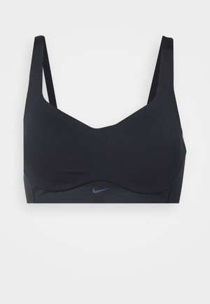 Crni sportski grudnjak od glatkog materijala, s bežičnim dizajnom, podesivim trakama i malim Nike logotipom tamnoplave boje na prednjoj strani.