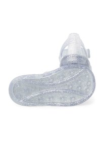 Transparent glittery sandal with a flexible sole, featuring a wavy design and small raised dots for grip, adjustable strap for secure fit.