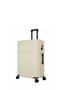 Hard-shell koffer in crème met verticale ribbelstructuur, zwarte uitschuifbare handgreep en vier zwarte wielen voor mobiliteit. Beveiligingsslot inbegrepen.