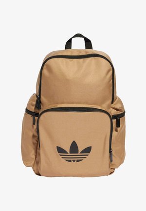 Tan backpack made from durable fabric, featuring a large main compartment, front zip pocket, black accents, and an embossed logo on the front.