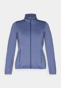 Ljusblå zip-jacka med hög krage, två framfickor med dragkedja och elastiskt tyg. Har en slät yta och figursydd design.