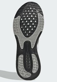Sohle eines Sneakers mit einem schwarzen und grauen Gummidesign. Verfügt über strukturierte Griffmuster und eine komplexe gitterartige Oberfläche für Traktion.