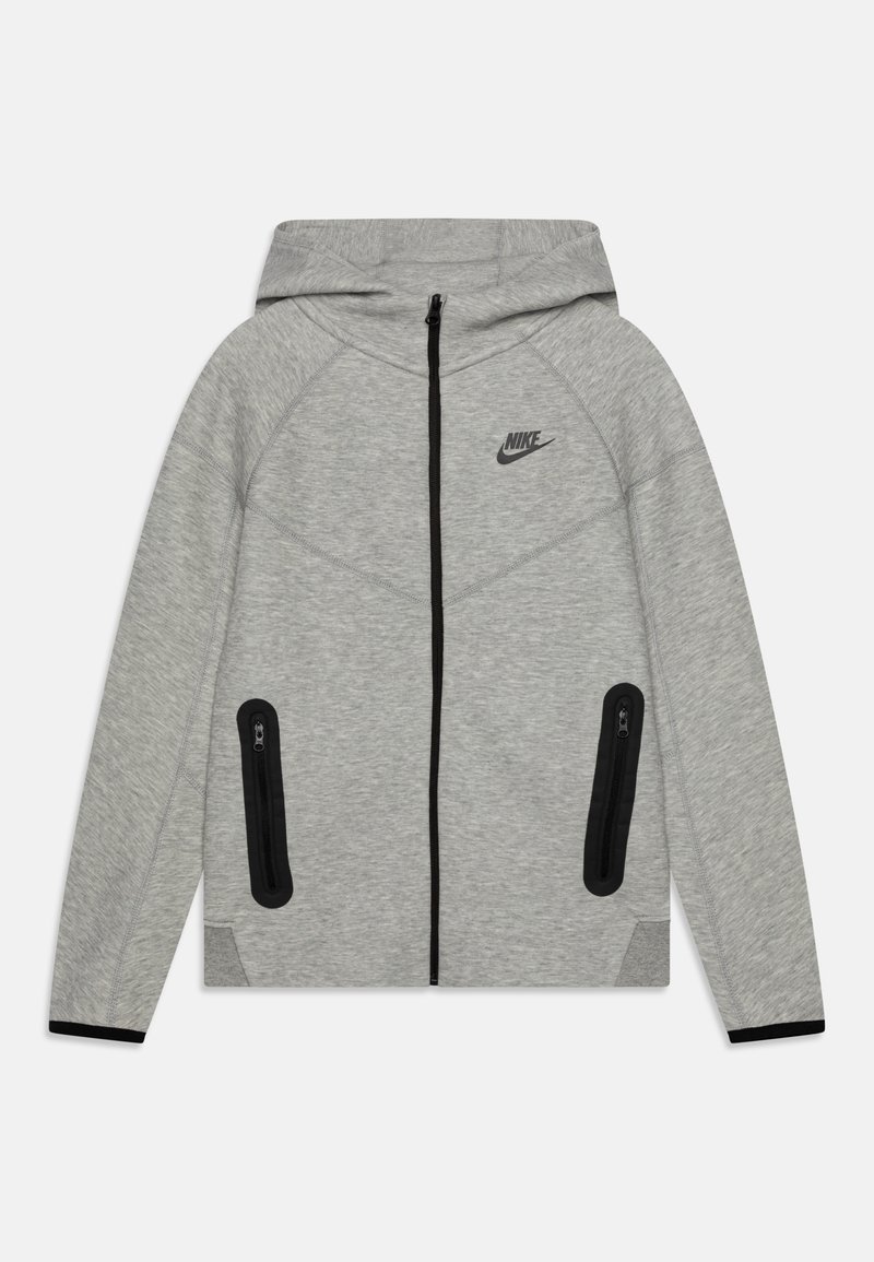 Grå Nike-hoodie med dragkedja fram, accentuerade sömmar, svarta dragkedjefickor på sidorna och en svart logotyp på bröstet. Mjuk textur.