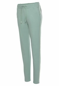 Hellgrüne Jogginghosen aus weichem Material, mit einem elastischen Bund und Kordelzug sowie seitlichen Streifen an den Beinen.
