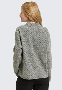 Gray knitted sweater with a textured diamond pattern, round neckline, and long sleeves. The back is smooth with a relaxed fit.