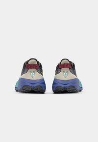 Sport shoes with a breathable mesh upper, dark gray and cream colors, accented with teal and blue rubber soles. Red laces and logo detail.