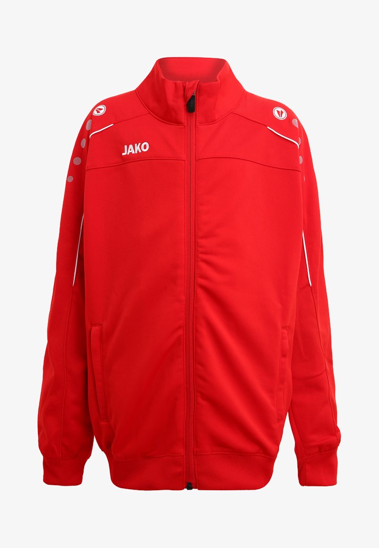Red athletic jacket with a zippered front, JAKO logo, white accents, and circular perforations on shoulders. Soft, smooth fabric texture.
