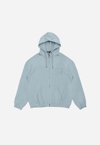 Haut de hoodie zippé bleu clair avec une capuche à cordon de serrage, des poignets et une taille élastiques, présentant un logo 3D subtil sur la poitrine gauche.