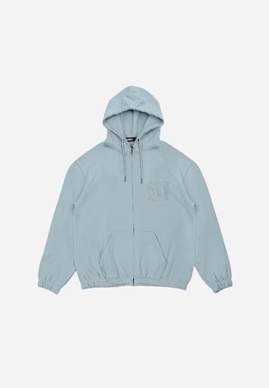 Light blue zip-up hoodie with a drawstring hood, elastic cuffs, and waistband, featuring a subtle 3D logo on the left chest.