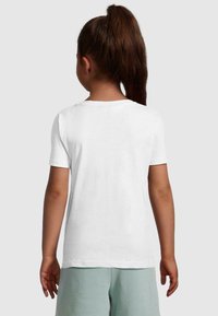 White short-sleeve t-shirt with a rounded neckline, made from smooth fabric. Worn with light green pants, showing a simple, clean design.