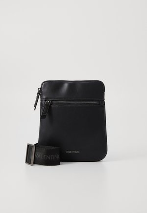 Black leather crossbody bag with front zipper pocket, adjustable branded fabric strap, and Valentino logo on the lower front.