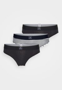Tre par med dametruser: to ensfargede svarte med elastisk midje og en svart-hvitt stripete. Stoffet er mykt og elastisk.