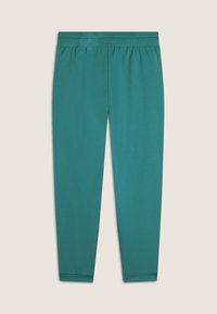 Leggings teal en tissu doux et extensible avec une taille élastique. Présente un design simple et des jambes cintrées avec des poignets ajustés.