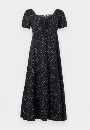 Vestito midi nero con pois bianchi, maniche corte a sbuffo, scollatura quadrata e un dettaglio frontale arricciato con fiocco.