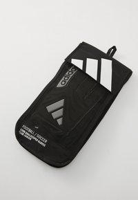 Black goalkeeper gloves bag made of durable material, featuring white adidas logo and stripes, with a mesh design and zipper closure.