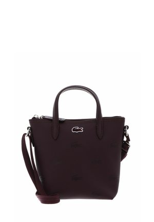 Small dark brown handbag with two handles, a detachable shoulder strap, and a small crocodile logo on the front center.