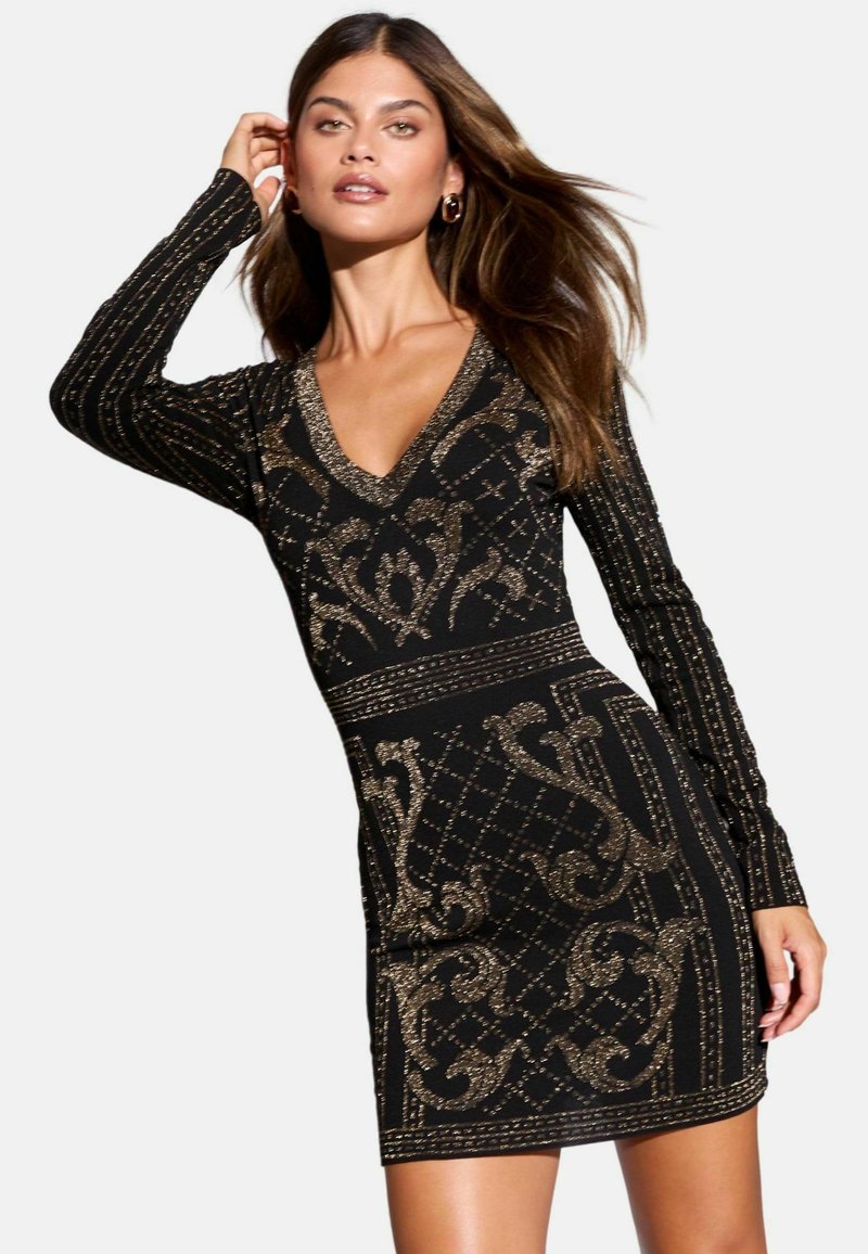 Rochie neagră cu mâneci lungi, decolteu în V, cu modele din sclipici auriu într-un design geometric. Benzi accent la talie și la manșete.