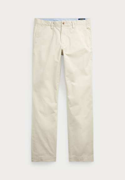 Beige bomullskjoler med rett ben-design, med glidelås og knappstenging, ekstra sidelommer og en ensfarget tekstur.