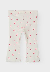 Helle beige Leggings mit verstreuten kleinen roten Herzen, ausgestelltem Schnitt am Ende und gewelltem Saum. Weicher, dehnbarer Stoff.