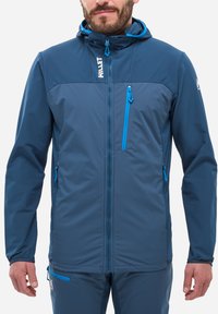 Veste multifonctionnelle bleue avec capuche, fabriquée en tissu texturé. Dotée de zips bleus contrastants et d'un logo en haut à gauche.