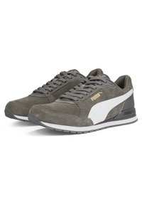 Šedé semišové tenisky Puma s bílým bočním pruhem, šedými tkaničkami a zlatým logem Puma, zobrazené z bočního pohledu na bílém pozadí.