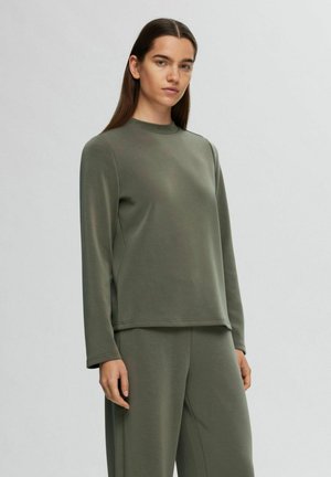 Khaki long-sleeve top with a high neckline, smooth texture, relaxed fit, featuring minimal stitching details, paired with matching wide-leg pants.