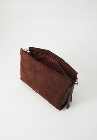 Brown suede clutch with a zip closure, featuring a smooth texture and a contrasting interior lining. Includes subtle hardware accents.