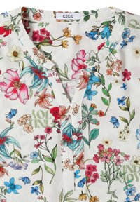 Blouse blanche à imprimé floral multicolore, boutonnée sur le devant, col rond et étiquette "CECIL" au niveau du col.
