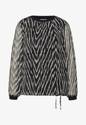 Svart och vit blus med chevronmönster, halvgenomskinliga ärmar, rund hals, elastiska manschetter och justerbar knytning i fållen.