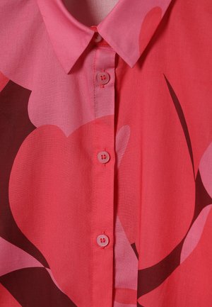Short-sleeved, button-up shirt in vibrant pink with large abstract floral patterns in darker shades, featuring a collar and smooth texture.