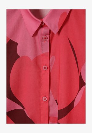 Lühikeste varrukatega, nööbitav särgi erkroosa toonis suurte tumedamate abstraktsete lillemustritega, millel on krae ja sile pind.