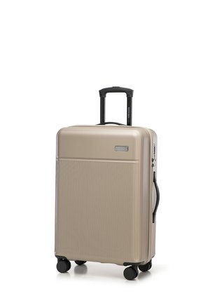 Hard-shell suitcase in metallic gold, featuring vertical ribbed texture, retractable black handle, and four black wheels for mobility.