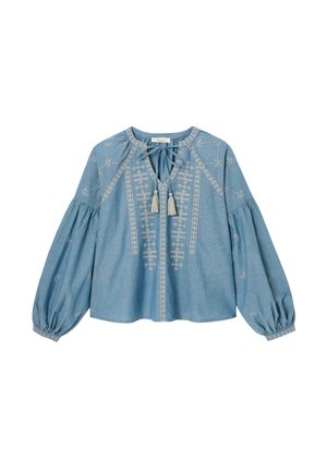 Blouse bleue à manches longues avec manches bouffantes froncées, broderie géométrique beige sur le devant, liens à pompons au col et poignets élastiques.