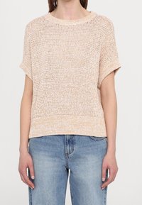 Haut en maille beige clair avec manches courtes, encolure ronde côtelée et coupe décontractée. Présente un motif texturé et un tissu doux et respirant.