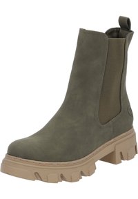 Botte de cheville en daim vert avec des panneaux latéraux élastiques, semelle beige épaisse, bout arrondi et une languette à l'arrière. Détail de surface texturé.