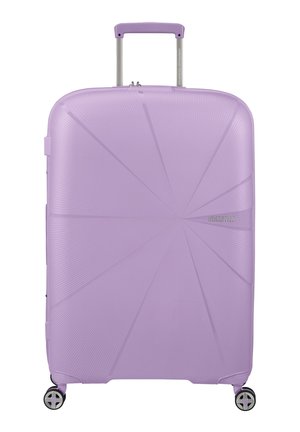 Purple hard-shell suitcase with a geometric design, textured surface, retractable handle, and four multi-directional wheels for mobility.