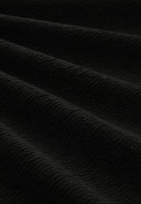 Schwarzer Textilstoff mit einer Wellenmusterung und subtilen Schimmer, der sanfte Falten und eine reiche, tiefe Farbe zeigt.