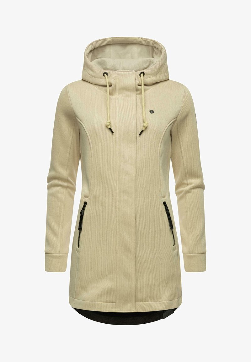 Beige kapucnis dzseki bordás textúrával, két cipzáras oldalzsebbel, kapucnin zsinórral és enyhén ívelt szegéllyel.