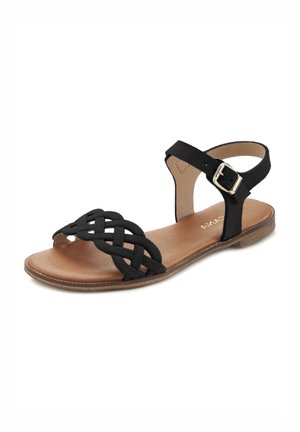 Black sandal with a woven front design, adjustable ankle strap, and a flat sole. Features a smooth brown insole and silver buckle detail.
