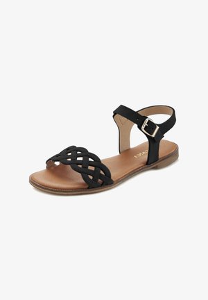 Black sandal with a woven front design, adjustable ankle strap, and a flat sole. Features a smooth brown insole and silver buckle detail.